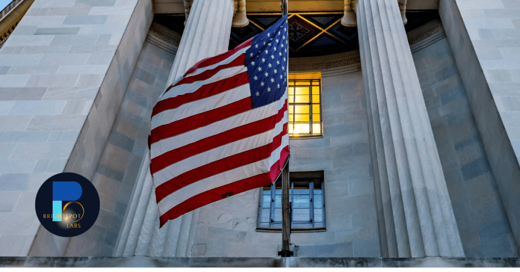 U.S. flag waving in front of a government building with BrightSpot Labs logo, symbolizing the influence of Department of Education changes on American students.