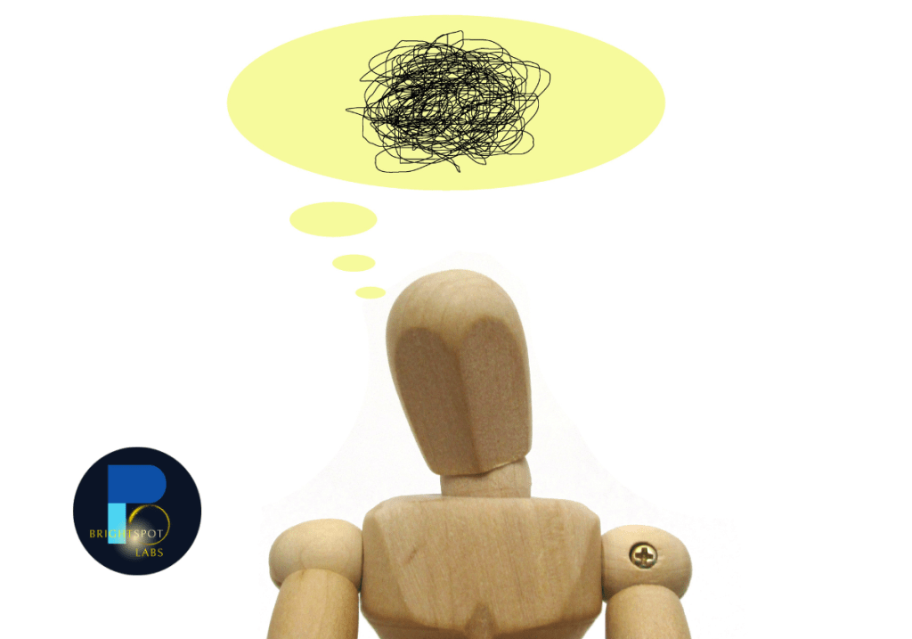 A wooden mannequin figure with a thought bubble containing a tangled scribble, representing confusion or complexity in understanding education policy changes. The BrightSpot Labs logo is positioned in the lower-left corner.