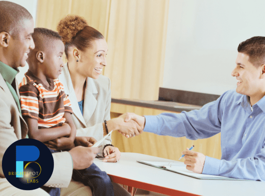 Parent and teacher shaking hands during school meeting to strengthen school-to-home connection
